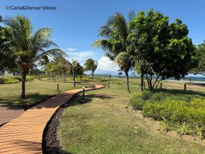 a wooden path through a park with palm trees at A perfect beach getaway in San Juan in San Juan