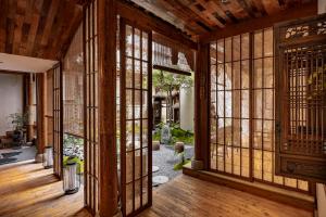 ein Eingang zu einem Raum mit Glastüren in der Unterkunft ChanYin Hotel in Chengdu