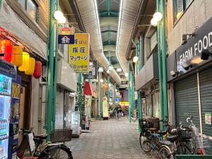 an alley with bikes parked inside of a building at Nogata Station 3 minutes on foot , 15 minutes to Shinjuku in Tokyo