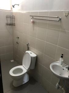 a bathroom with a toilet and a sink at Zahara Homestay in Sandakan