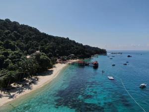 an aerial view of a beach with boats in the water at Chatek Family Inn in Kampong Pasir Hantu