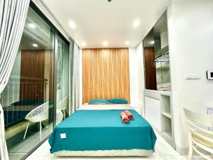 a bedroom with a blue bed and a balcony at Cozy And Comfortable Studio Apt In City Centre Near Marriott and Keangnam in Hanoi +90 photos