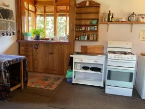 a kitchen with a stove and an oven at Secret Forest Cabin in Jackeys Marsh +46 photos