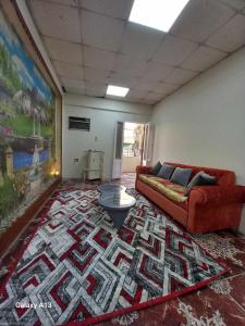 a living room with a couch and a rug at شقة سكنية in Shibīn al Kawm