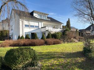 una gran casa blanca con un patio delante en Ruhrtalblick Apartments - Auszeit mit Ausblick, en Meschede