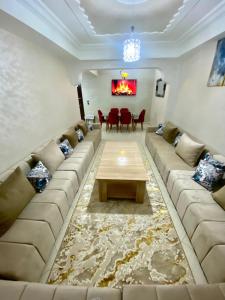 a living room with a large couch and a table at casa bella in Casablanca