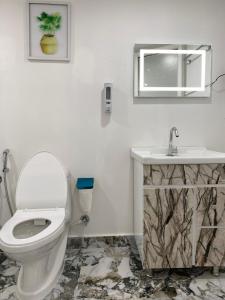 a bathroom with a toilet and a sink at Mystic Nest in Canacona