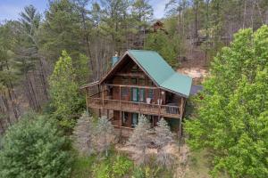 an overhead view of a house in the woods at Cozy Cabin with views, hot tub, fishing pond, and game room in Sevierville