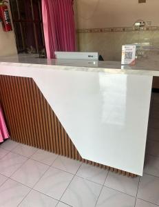 a white counter top with a brown stripe at Melayu Asri Hotel in Negara