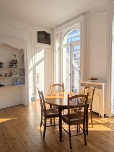 a dining room with a table and chairs at Lille hypercentre - Charming T2 with balcony in Lille +9 photos