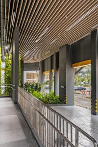 an external view of a building with a wooden ceiling at Beverly Hotels Elements in Singapore +6 photos