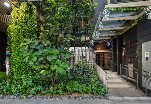 a large green wall in the side of a building at Beverly Hotels Elements in Singapore