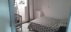 a bedroom with a bed and a stair case at Paille en queue des z iles in Saint-Pierre