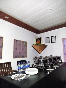a kitchen with a counter with bottles of water at Ibex spangri cottage in Lukung