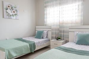 a bedroom with two beds and a window at Royal seacrest А203 sea view apartment in Paphos City +38 photos