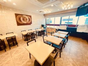 a restaurant with tables and chairs in a room at APA Hotel Tokushima Ekimae in Tokushima