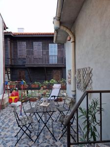 a patio with chairs and a table on a balcony at Apartament Magi in Sozopol