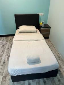 Rúm í herbergi á Sky View Hotel Dengkil Putrajaya Cyberjaya