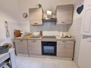 a small kitchen with a stove and a sink at La Chiocciola in Trani