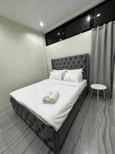 a bedroom with a bed with two towels on it at Kristinas Aparthotel Kabankalan in Kabankalan +14 photos
