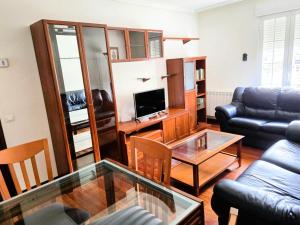 a living room with a couch and a table at Balcón de San Lorenzo in Ezcaray