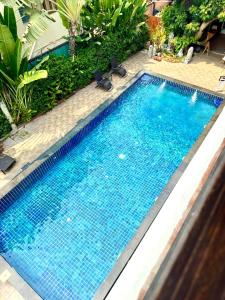 a swimming pool with blue water in a yard at BB Mantra Boutique Hotel in Chiang Mai