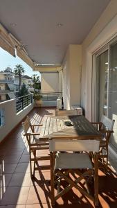 a wooden table and chairs on a balcony at Modern Flat in Nafplio in Nafplio