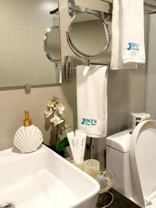 a bathroom with a sink and a toilet and towels at Jony's Boutique Hotel in Boracay +32 photos