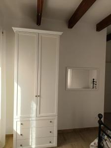 a white cabinet in a room with a ceiling at Bed breakfast L'AMICO in Alghero +23 photos