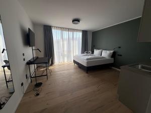 a bedroom with a bed and a television in it at New Age Boardinghaus Bad Rappenau in Bad Rappenau