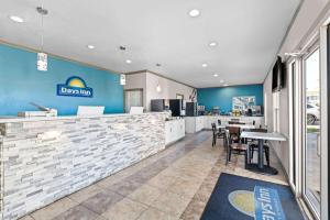 a restaurant with blue walls and a table and chairs at Days Inn by Wyndham Gainesville in Gainesville