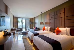 Postel nebo postele na pokoji v ubytování Wyndham Tamansari Jivva Resort Bali + 37 fotografií