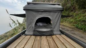 a tent with a bed in it on a hill at Geko camper in Funchal