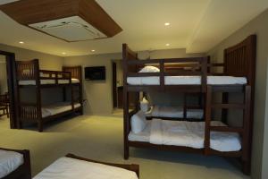 a room with three bunk beds in a room at Chakkra Grand in Madurai
