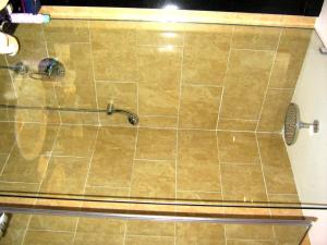a shower in a bathroom with a tile floor at Hotel Restaurant Bären in Freudenstadt