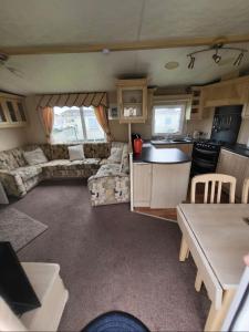 a kitchen and living room of a caravan at SKEGNESS GOLDEN PALM HOLIDAY HOME Pg 52 in Skegness