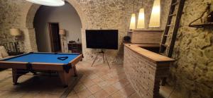 a room with a pool table and a tv at La Masia in Sant Pau dʼOrdal