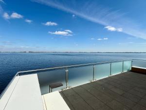 a deck of a boat in the water at Houseboat Robbedoes in Offingawier +23 photos