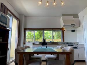 a kitchen with a table and chairs in a room at Painagama House in Miyako-jima