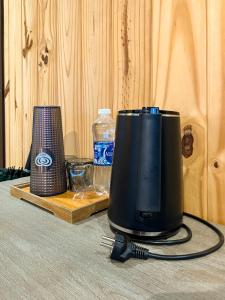 a blender sitting on a table with a bottle of water at The Lake House Retreat & Watersports in Tân Phú
