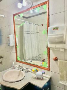 a bathroom with a sink and a mirror at G H Hostal VIP in Buenos Aires +32 photos