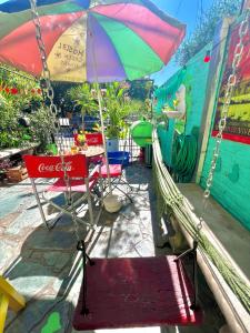 a patio with chairs and an umbrella and a hammock at G H Hostal VIP in Buenos Aires