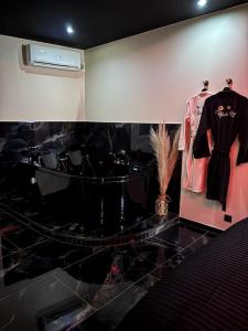 a room with two mannequins and a shirt on display at Romantique room,balnéo,mirroir,parking in Grenoble