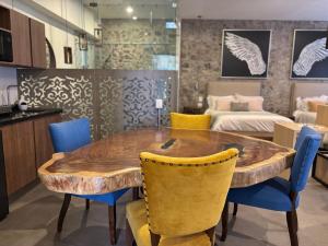 a dining room with a wooden table and blue chairs at Castello di Carlo - Loft Carlo II in Santeagueda
