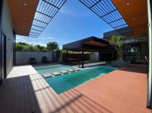 a swimming pool in the middle of a house at Kompletia Pool villa in Sattahip