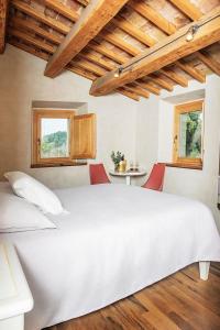 a bedroom with a large white bed with red chairs at Agriturismo Montecolombo by Il Ritorno in Sirolo