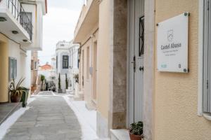 a street with a sign on the side of a building at Castel Abaso Boutique Apartments by Explore Andros in Andros
