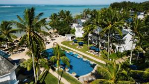 an aerial view of a resort with a swimming pool and the ocean at Heritage Le Telfair Golf & Wellness Resort in Bel Ombre