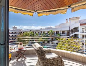 a balcony with two chairs and a table on a building at Santos Lerch Sol Apartment in Puerto de Santiago