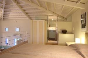 a bedroom with a large bed and a mirror at Elies Houses in Agnontas